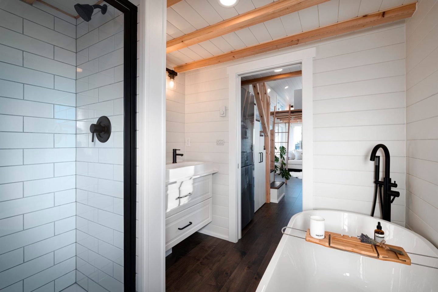 The 34ft Eco-Friendly Tiny House RV's bathroom includes a shower, bathtub, sink, and composting toilet