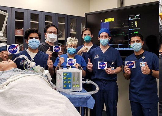 doctors at the Icahn School of Medicine at Mount Sinai in New York City give a thumbs up after testing a ventilator prototype