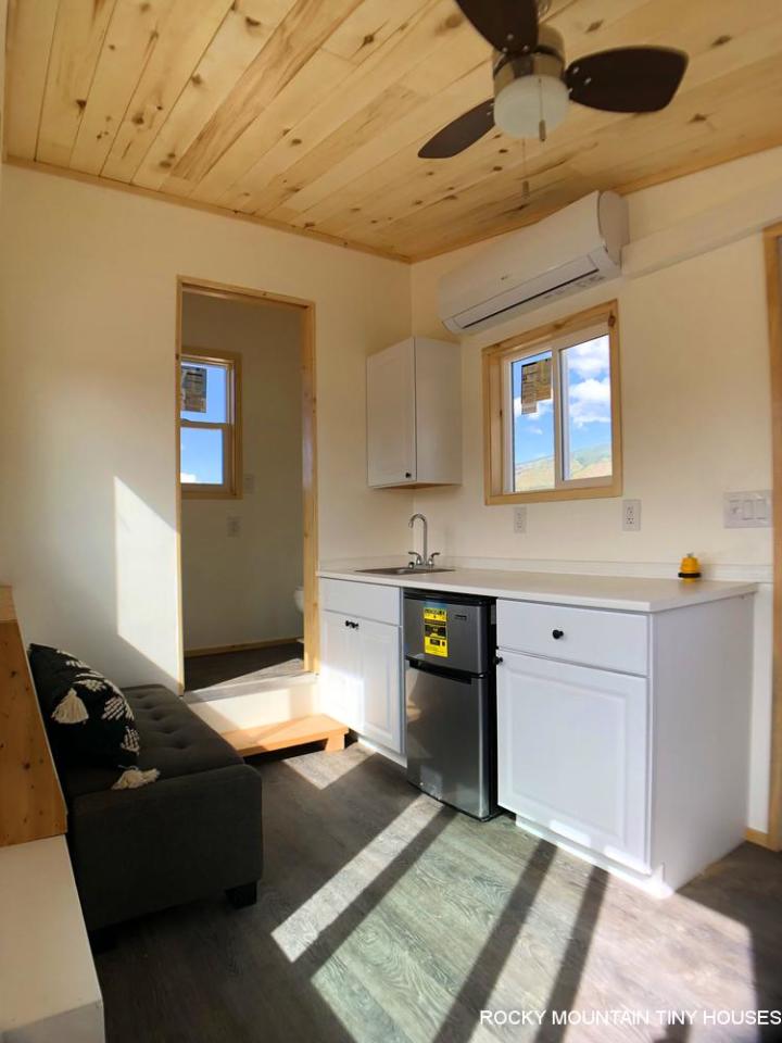 The City of Aspen Carpool Kiosk includes a basic kitchenette with a sink, fridge, some cabinetry, a microwave, and a coffee maker