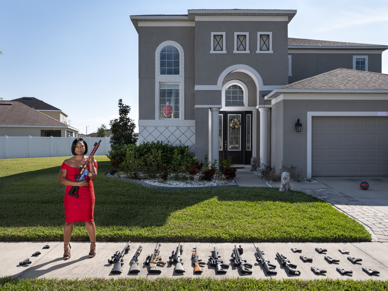 2nd Place - Avery Skipalis (33), outside of her house, posing together with all the firearms she owns, Tampa, Florida
