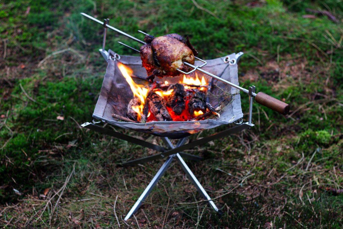 Whole chicken sizzling over the fire