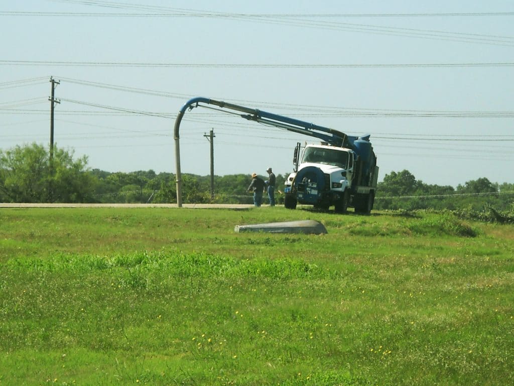 Figure 1. Pump Truck clearing the discharge line from the Polishing Pond to the Effluent Discharge Basin 