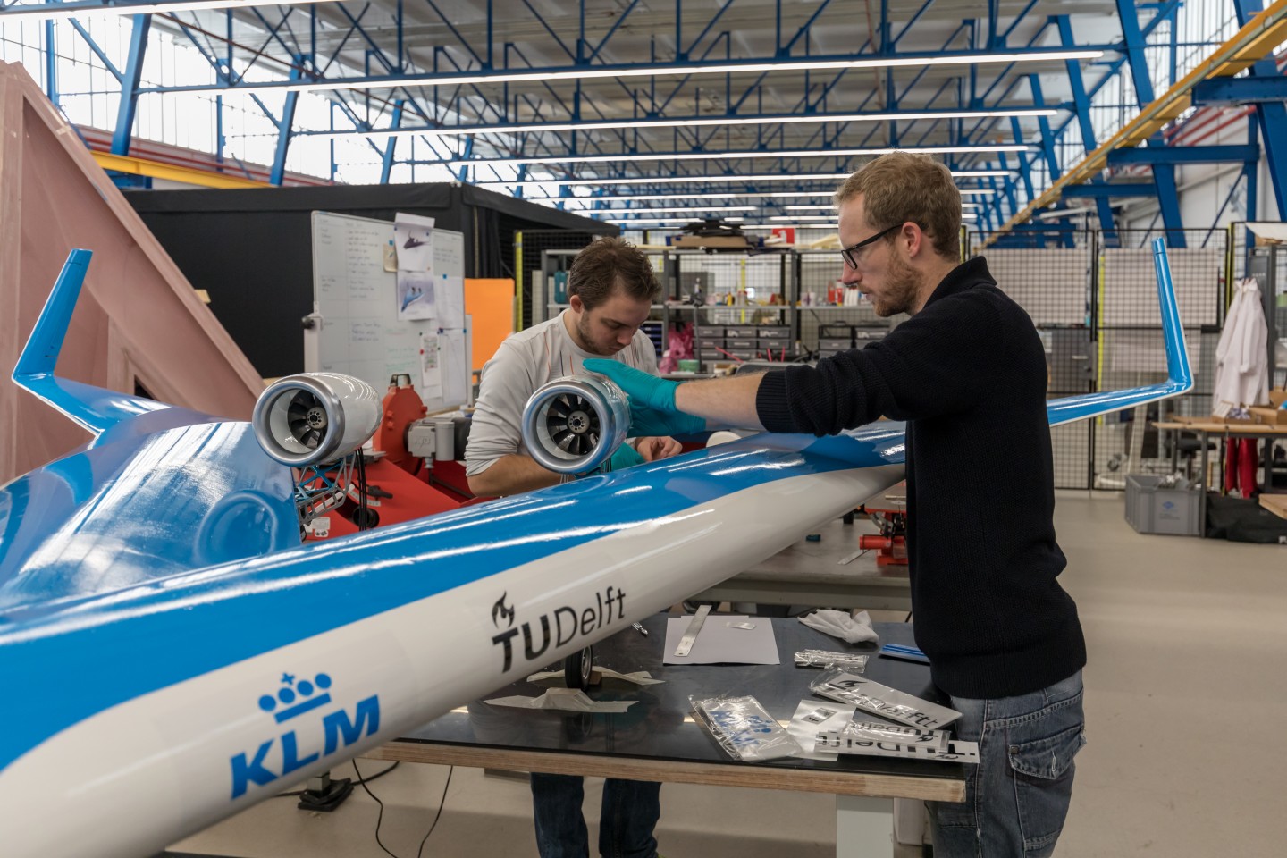 The team tinkers with the scale model of the Flying V airplane