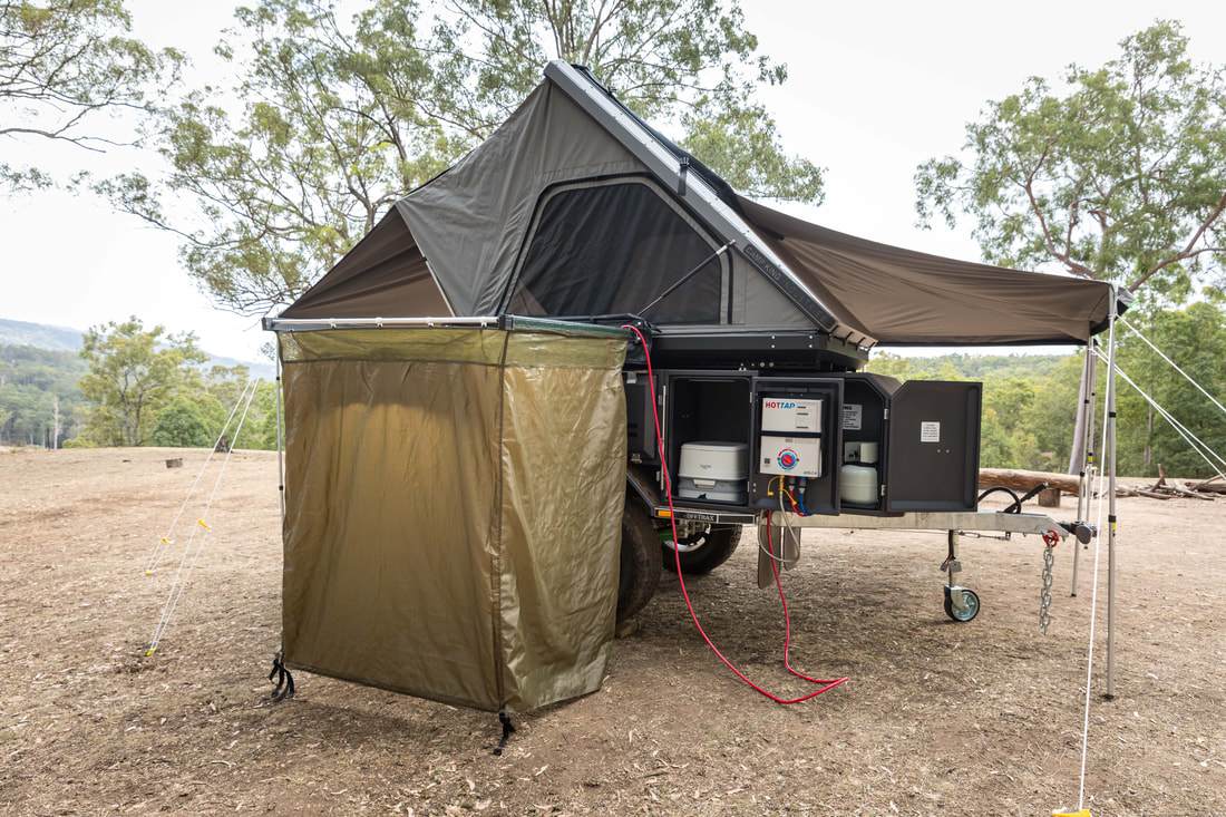 With a standard hot water heater, shower tent and portable toilet storage, the Offtrax packs a full outdoor bathroom