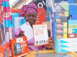 A mobile phone seller displays various models of mobile phones as Nigeria’s mobile broadband market is projected to grow