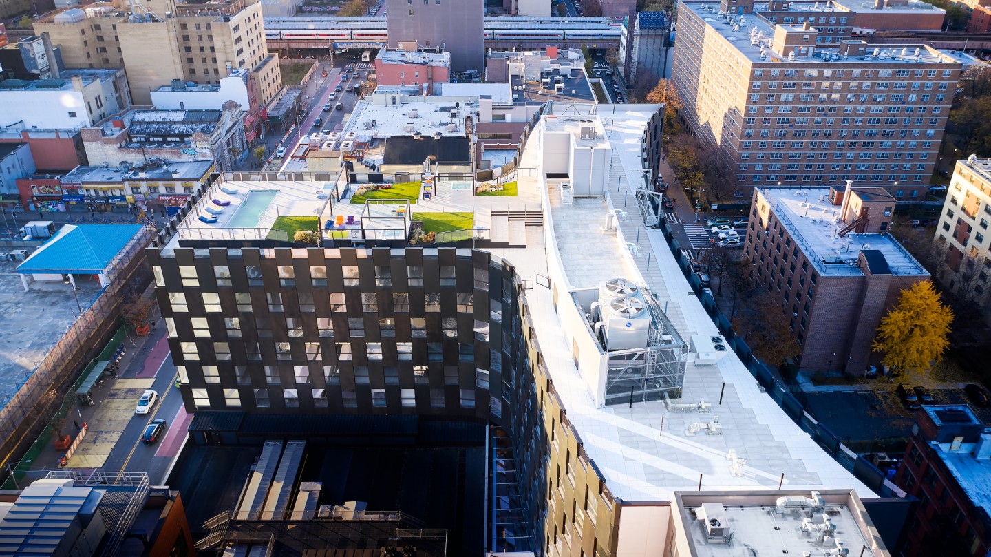 The Smile takes the overall form of a three-pronged Y-shaped structure stretching between two streets and partly cantilevering over an existing commercial building