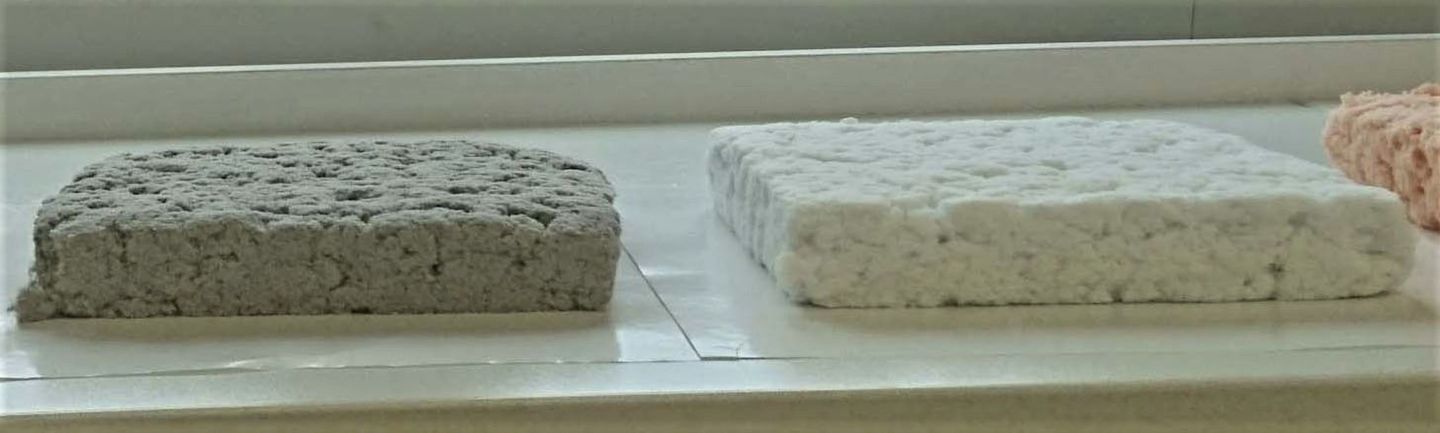 A 3-cm (1.2-in)-thick mat of the standard material made from recycled paper (left), along with an experimental mat made from virgin cellulose fibers