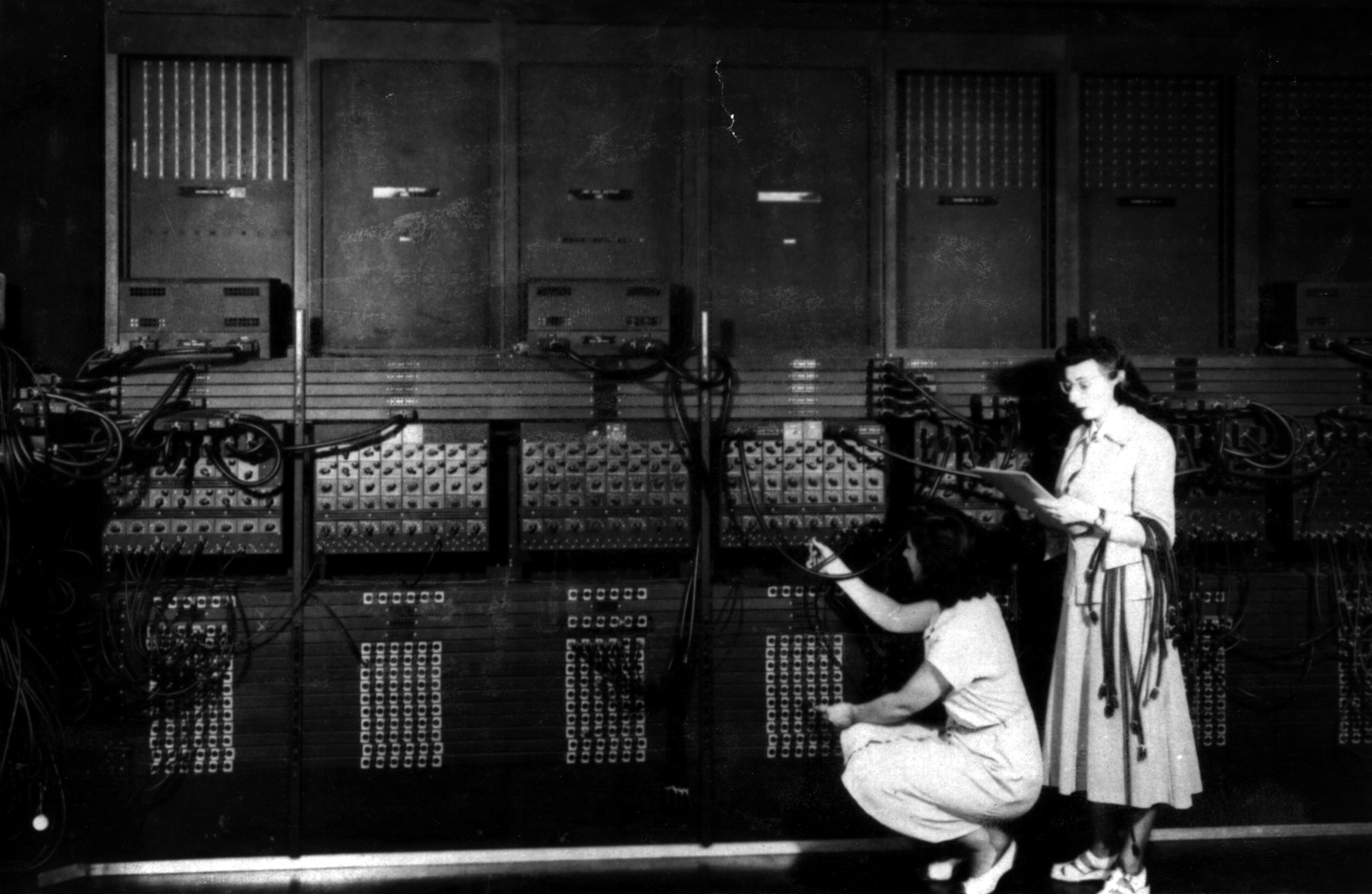 A section of ENIAC with two of its programmers