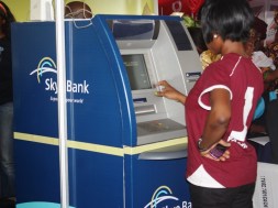 A bank staff seen using an ATM at an exhibition showcasing banking technologies and services in Lagos