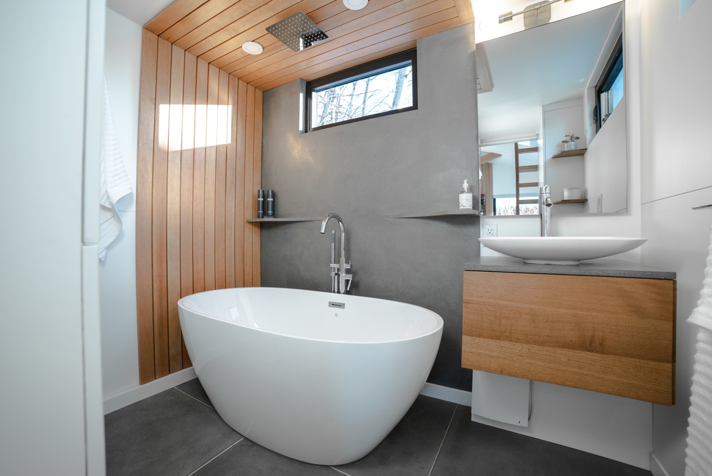 The luxury bathroom suite with full-sized bathtub, heated mirror and rain shower head