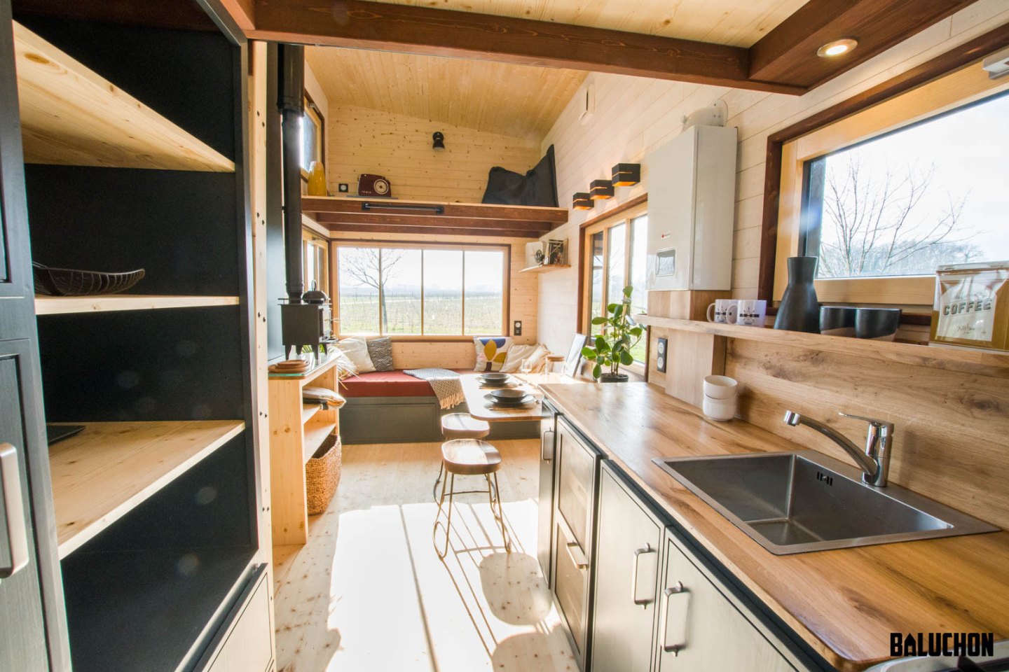 Tiny House Road Runner's kitchen has some wardrobe space and shelving for the owners' clothes