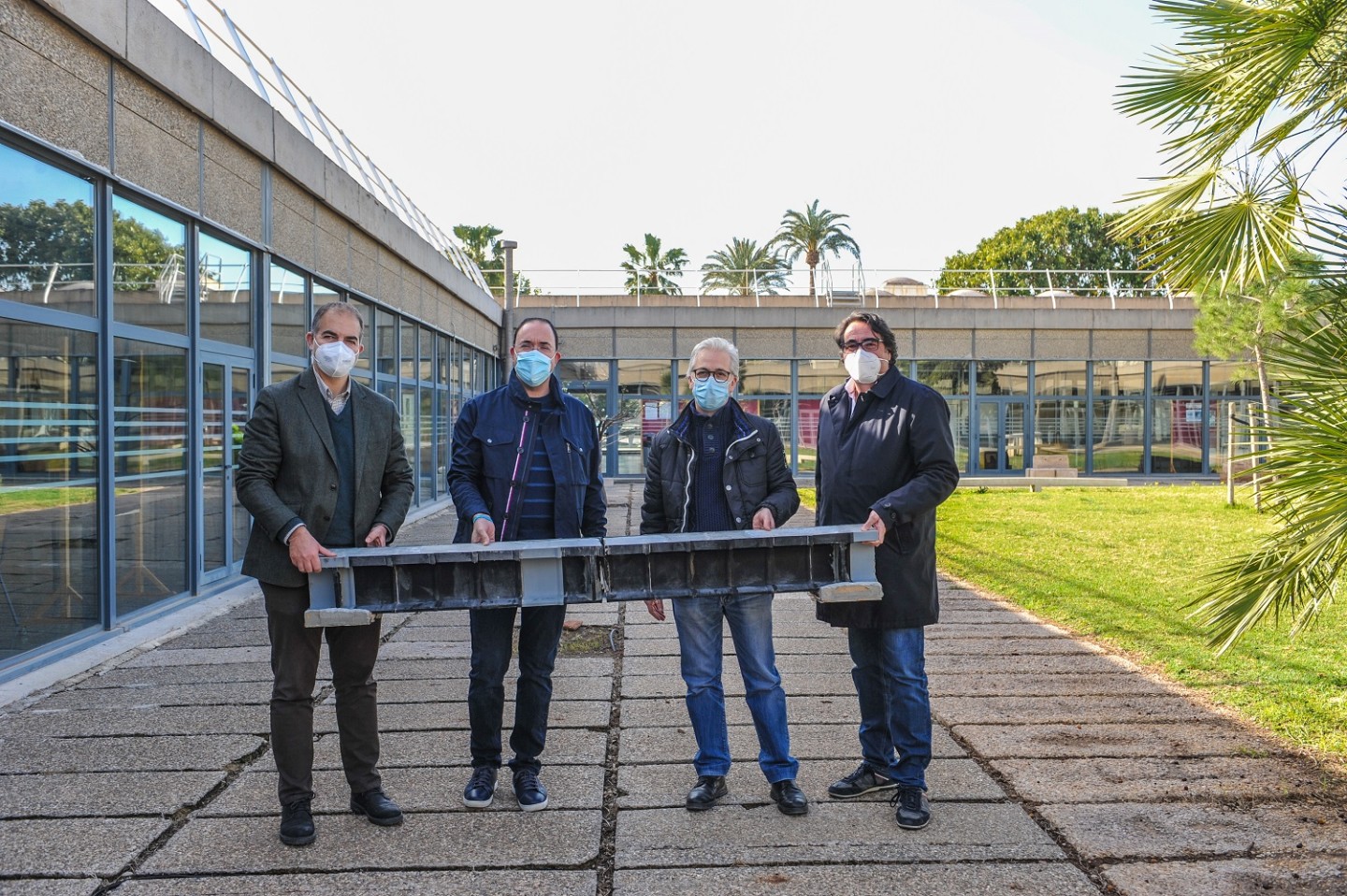 The Polytechnic University of Valencia research team with one of its 3D-printed beams