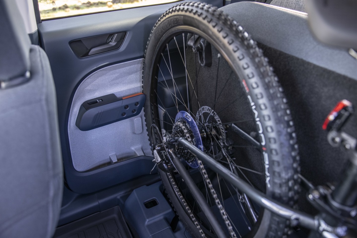 Slots in the rear door handles allow a bicycle tire to slide between, extending the rear cabin's width enough to accommodate most mountain bikes