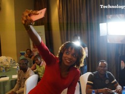 A lady seen taking selfie photograph at a mobile phone launch event in Lagos
