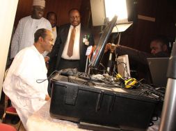 President Muhammadu Buhari, seated, undergoing the biometric capture by officials of the National Identity Management Commission (NIMC) in Abuja