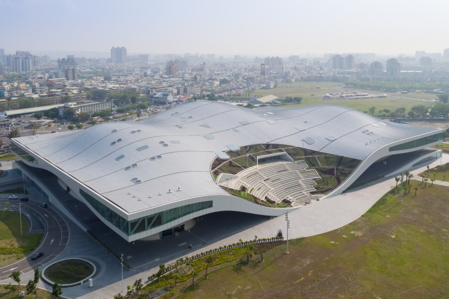 The National Kaohsiung Centre for the Arts in Taiwan houses a huge public plaza under its undulating roof