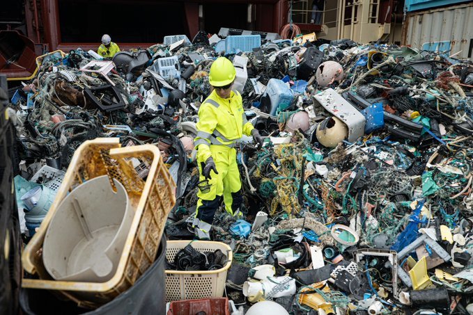 An Ocean Cleanup Project team member sifts through the plastic waste