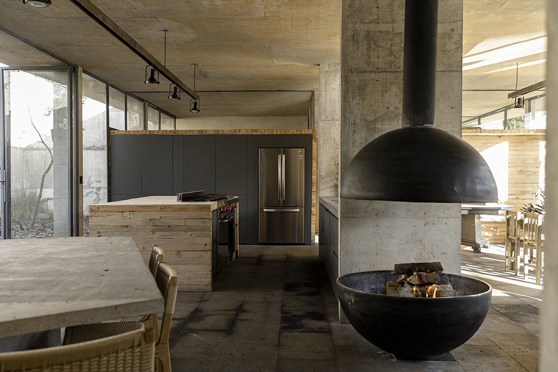 The Avocado House's interior decor is a mix of rough concrete, wood, stucco, and glass
