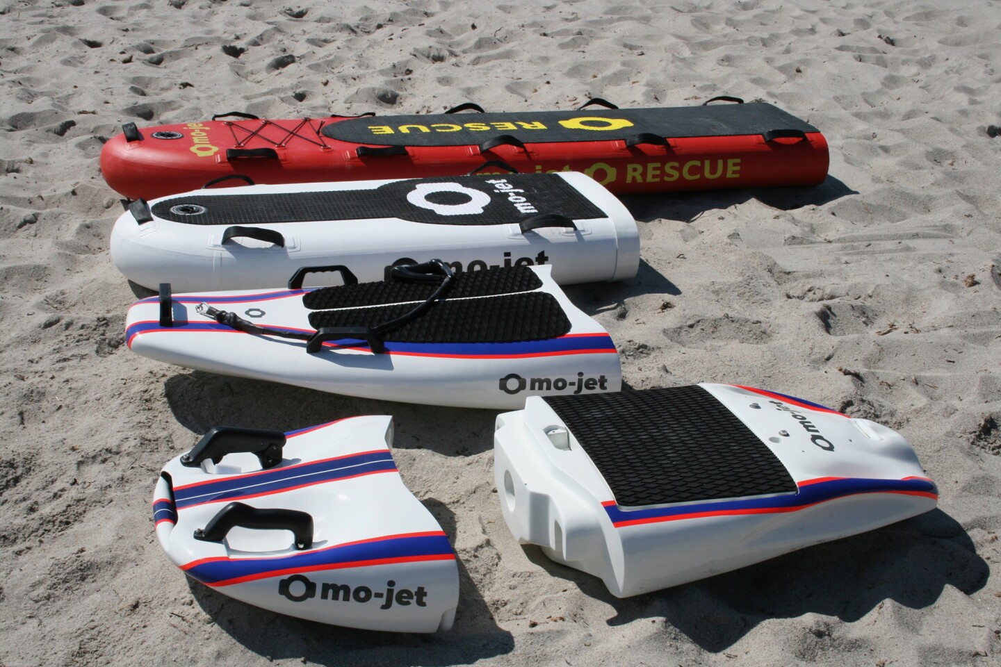 From top to bottom, the mo-jet Rescue, Surf Air, Surf and Bodyboard front modules, with the rear power module to the right