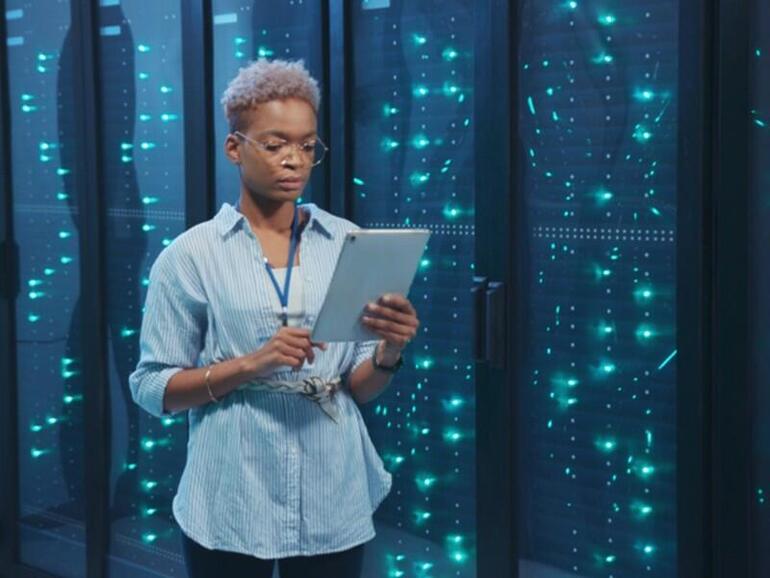 Woman system administrator looking at tablet