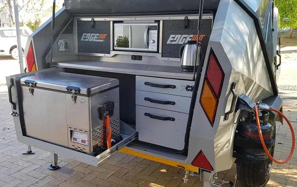 Simple but effective, the Edgeout tailgate kitchen comes with a dual-burner stove, basic sink setup, slide-out for fridge/freezer and available microwave