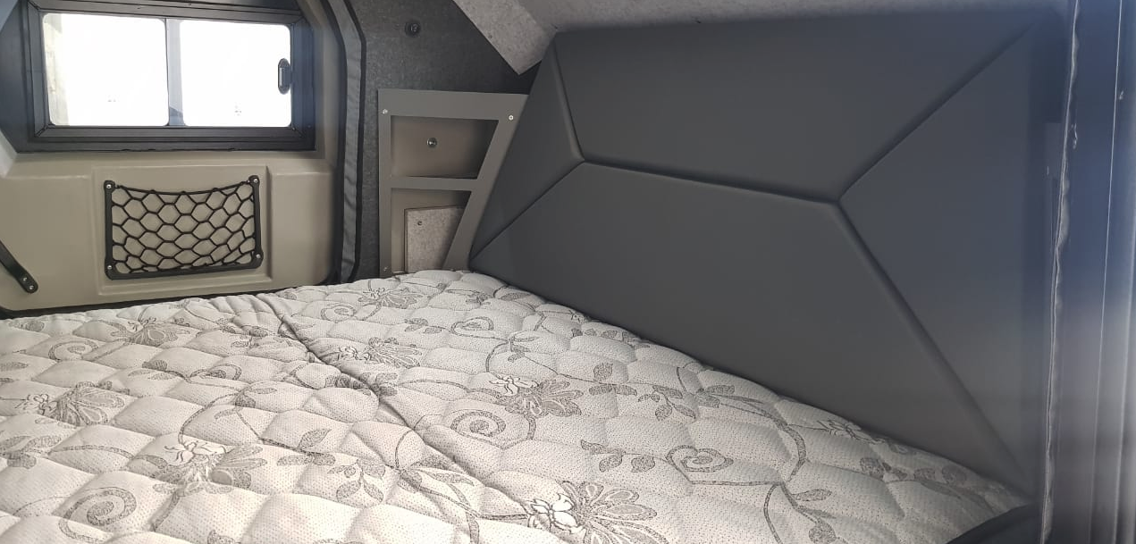 The interior includes a 5.5-in-thick queen-size mattress