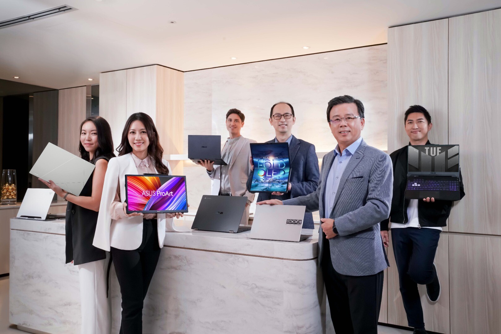 The Zenbook 17 Fold OLED laptop (center back) takes its place among the CES 2022 product launches from Asus