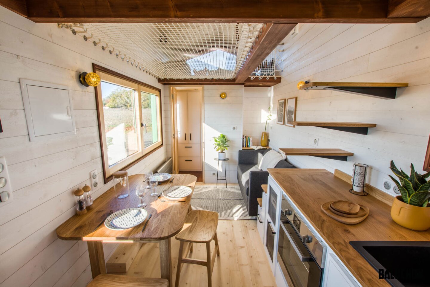 The Tiny House Planedennig's upper level is reached by steps integrated into the kitchen counter
