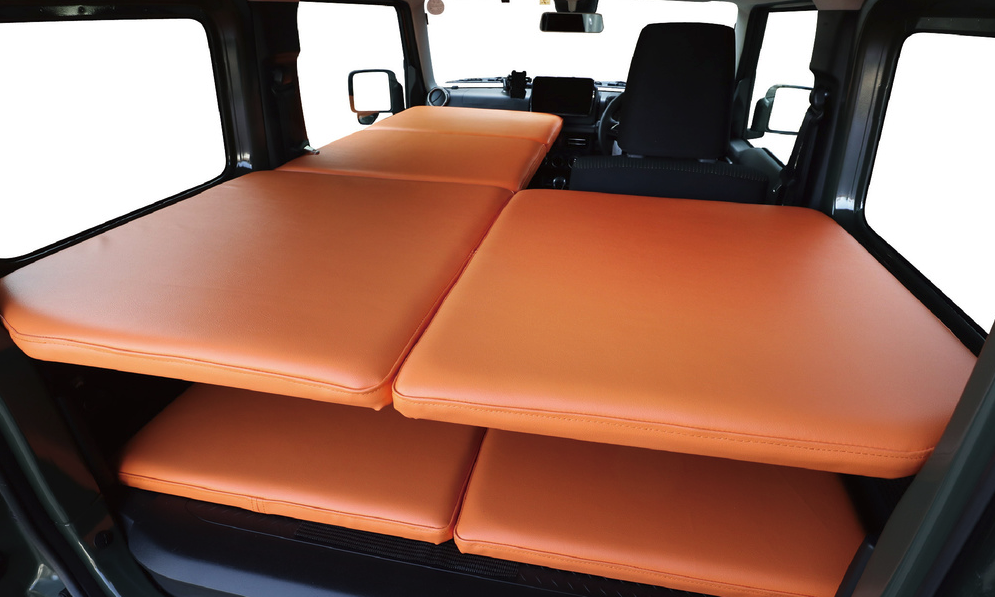 The L-shaped single bed layout allows the solo camper to keep the driver's seat up