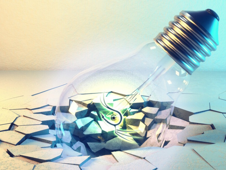 Concept of a lightbulb smashing a table