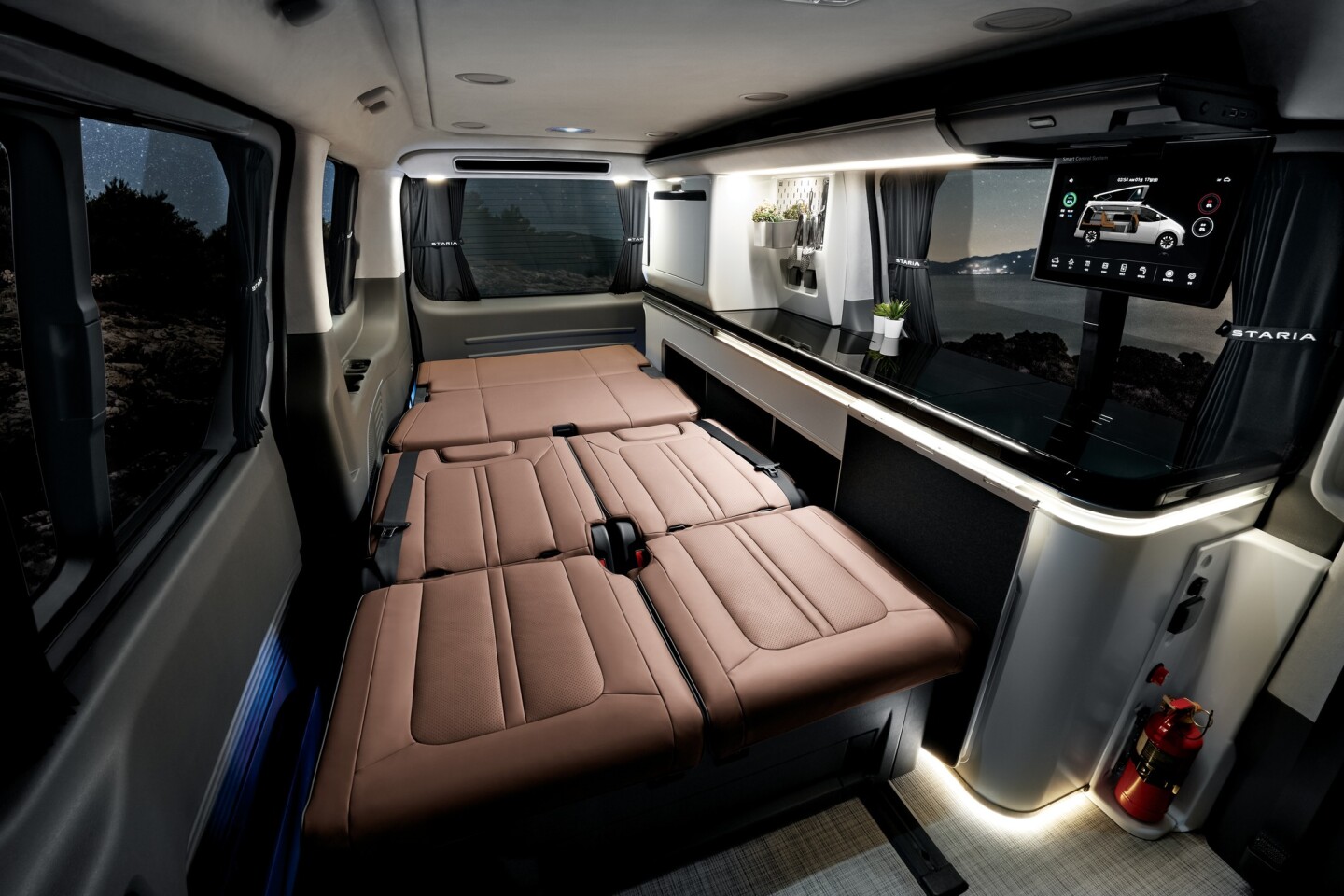 The Camper 4 includes a long sidewall kitchen/storage console and a fold-down lower bed