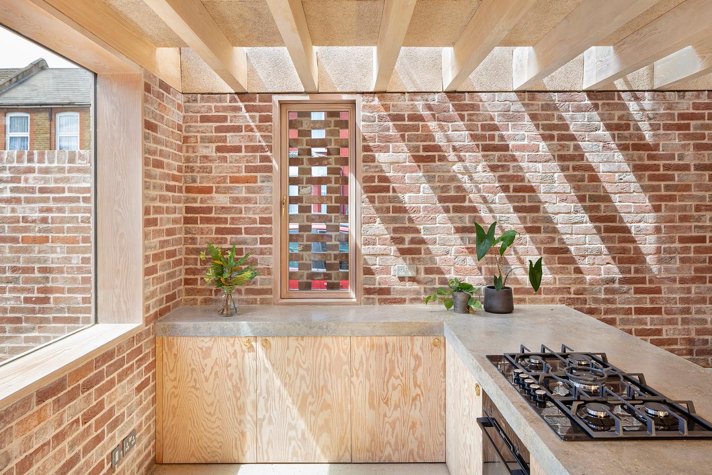 Leyton House has a compact interior that's light-filled and leaves the brickwork exposed