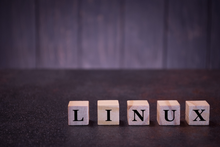 The word linux on wooden cubes, on a dark background, symbols signs