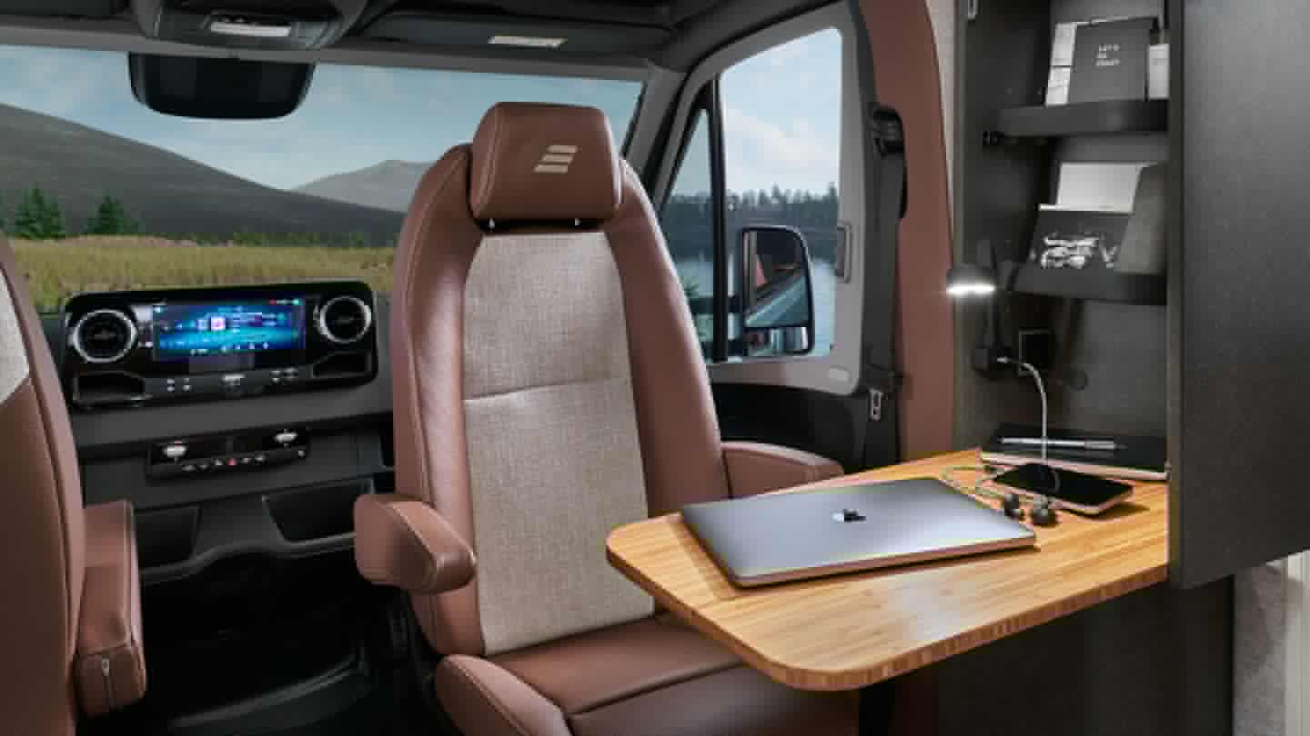 A console with foldable desktop and storage shelves creates a dedicated front workstation perfect for modern untethered workers