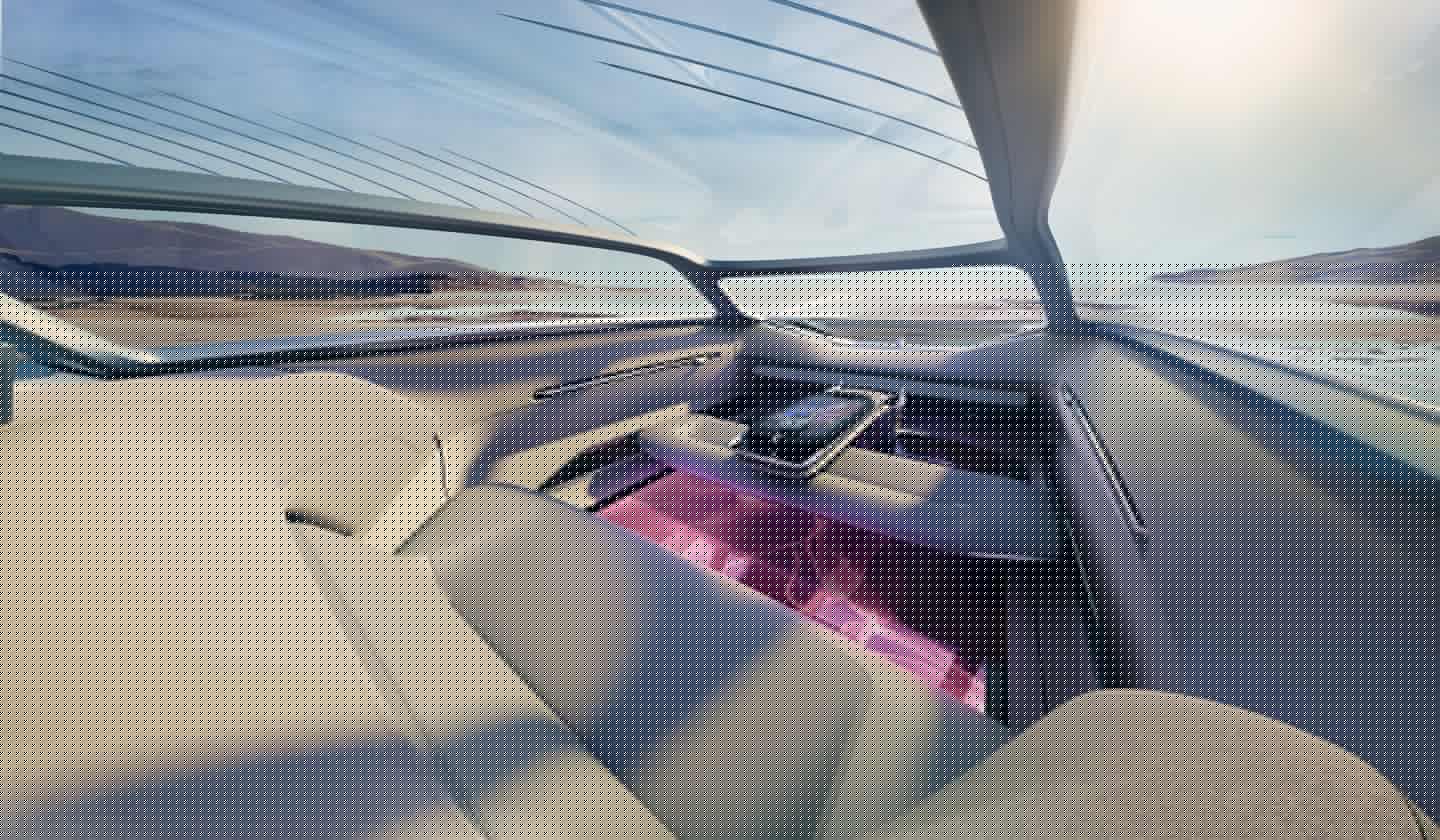 The interior includes a rear sofa, convertible front bench seating and a center console contro center