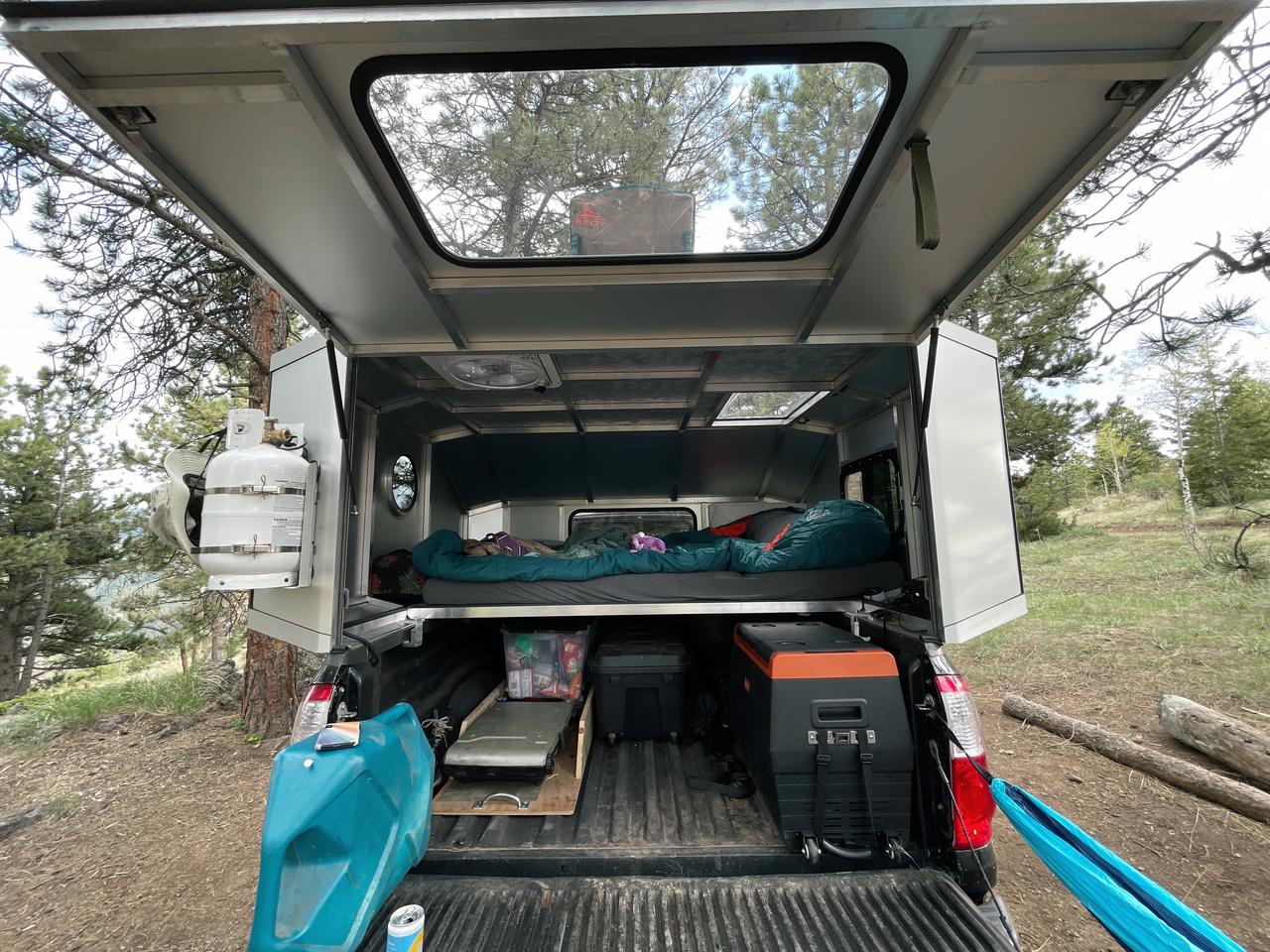 The sleeping platform sits atop the pickup bed sides, leaving the entire bed free to use, including for taller equipment like a fridge