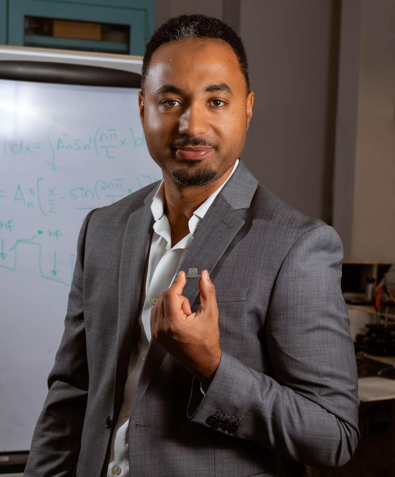 Goddard engineer Berhanu Bulcha holds the tiny quantum cascade laser