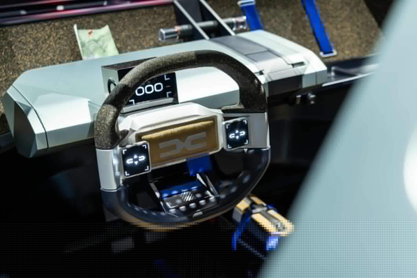 A simple no-fuss interior with digital dash, angular steering wheel and a pop-up compartment to host a driver's smartphone