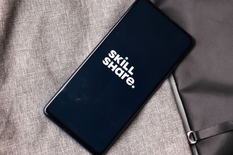 Phone with the Skillshare logo.