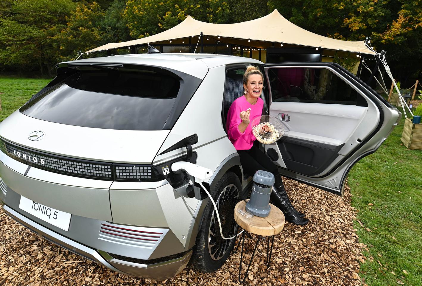 The Hyundai Hotel has been curated with broadcaster Grace Dent, seen here enjoying popcorn and an espresso made with gadgets powered by the Ioniq 5