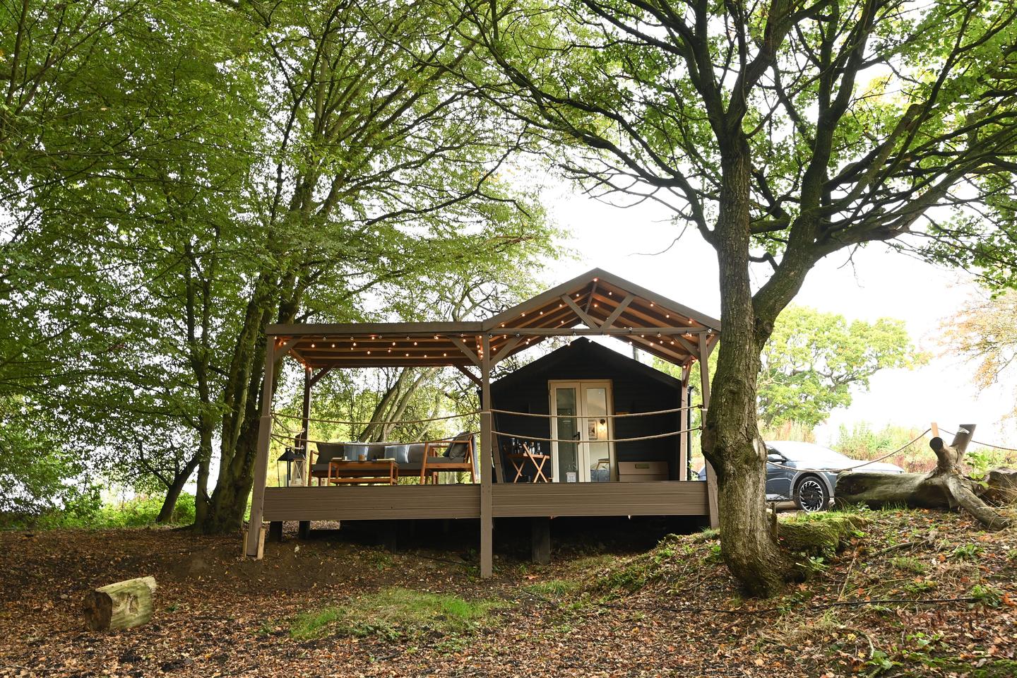 The cabin can accommodate two guests, boasts an open-plan living space, single bedroom with double bed and ensuite bathroom, and outdoor decking with firebowl and BBQ