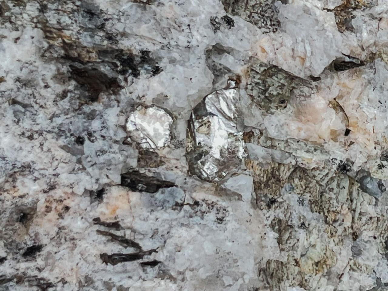 Telltale flashes of silver-white lithium metal in the rock