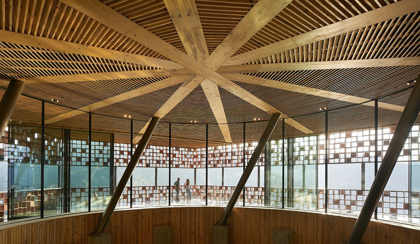 A giant geometric circular ceiling creates a centerpiece of the distillery