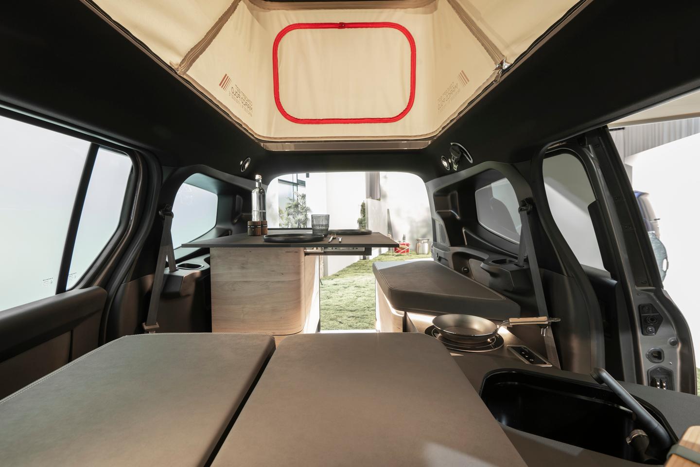 On the Mercedes-Benz Concept EQT Marco Polo's front dining bench next to the kitchen