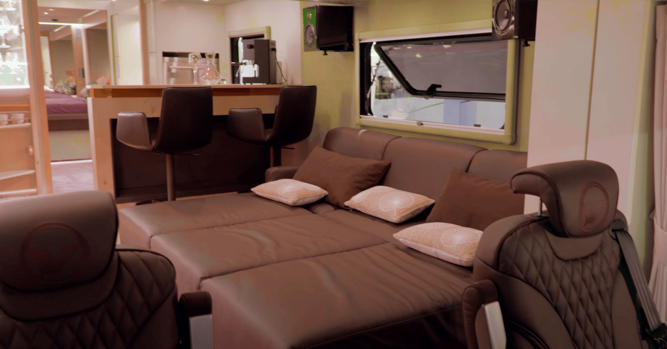 The custom floor plan includes a front daybed and a two-person bar