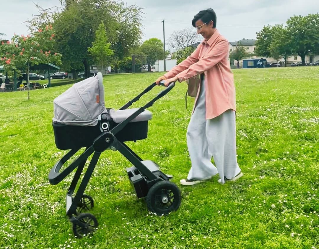 An Ella prototype uses its motors for assistance while being pushed through soft grass