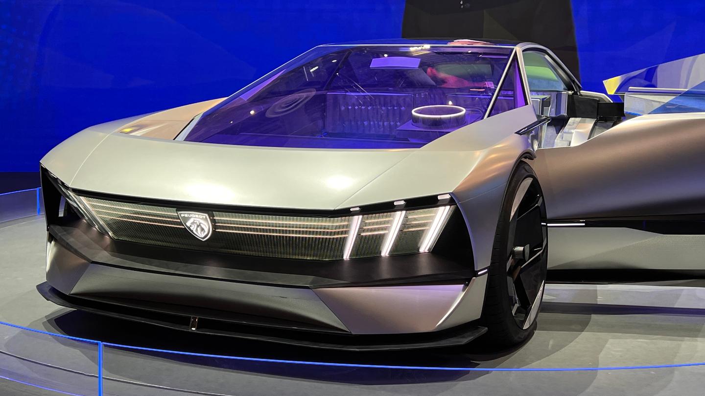 The Inception wears a single-piece front-end that unifies the large illuminated logo and triple-claw headlamps with three thin horizontal strips