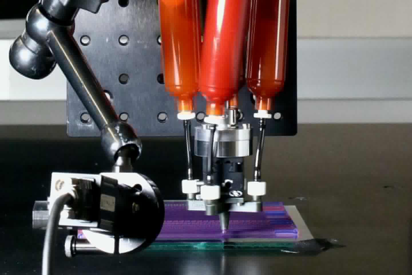 The rig used to produce the filaments, with the ink cartridges at the top and the rotating nozzle at the bottom