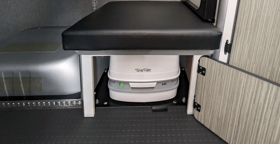 The portable toilet hides away in a purpose-built bench cabinet