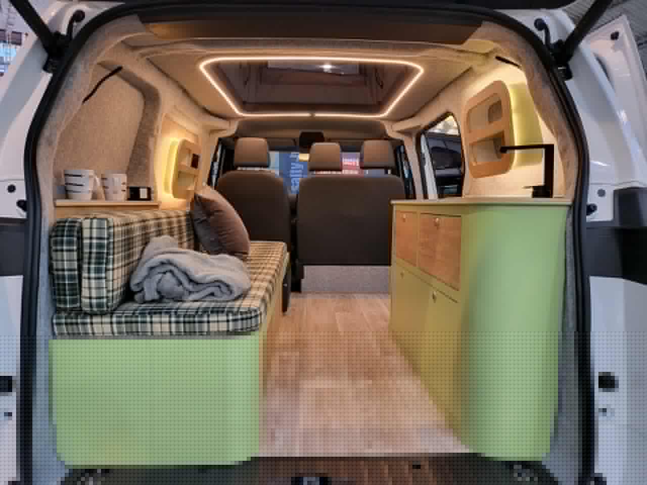 Alpincamper makes the most of the VW ID. Buzz's limited space, opening up standing height with a central pop-up roof panel